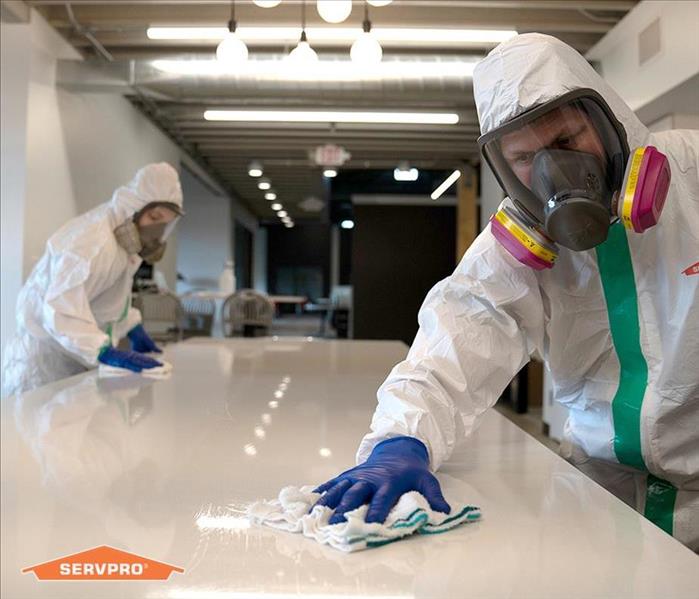 SERVPRO technicians cleaning table
