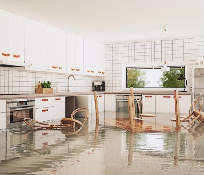 a flooded kitchen with furniture floating in the water